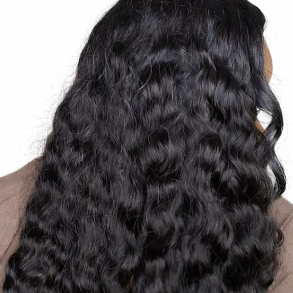 Close-up of a person with long, black, , raw wavy hair 